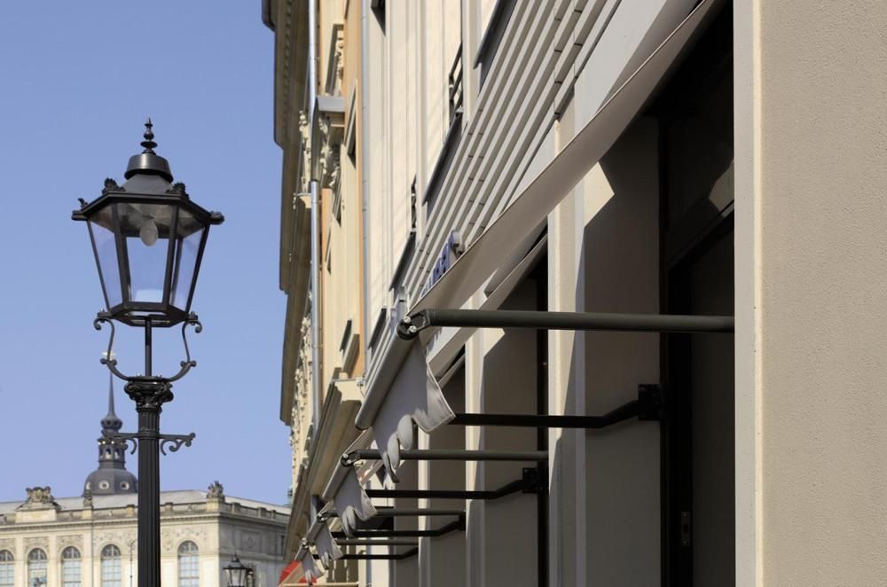 Drop arm awnings installed on a store front